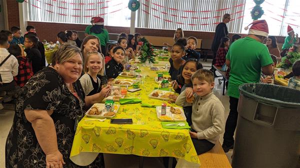 Students dress up and get served a fine meal. 